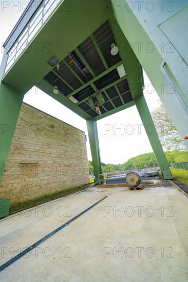 Industrial structure with green construction and machinery on an outdoor concrete floor, Glems
