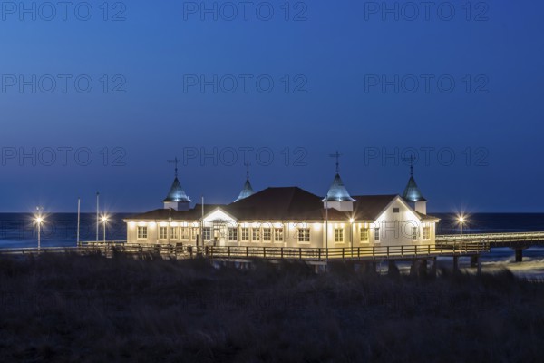 Restaurant on Ahlbeck Pier, Seebrücke Ahlbeck illuminated at dusk in the Baltic Sea on Usedom
