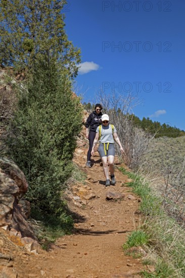 Idledale, Colorado - Hikers on the Bruin Bluff Trail in Lair o' the Bear Park. The park is part of