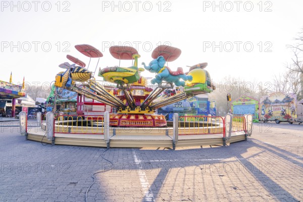 Children's carousel with colourful figures and a cheerful atmosphere at a fair, Fasnet, Weil der