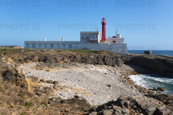 Lighthouse on rocky coast with clear sky and sea view, Farol do Cabo Raso, São Brás de Sanxete