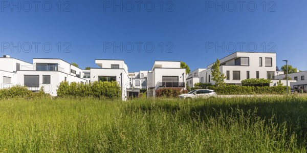 Modern detached houses with heat pumps in new development area, energy-saving house, efficiency