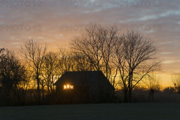 Sunset, sky burning, evening sun shining through a window of a house, house on the Dijkweg,