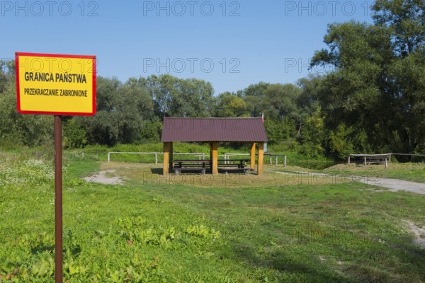 Border sign and wooden shelter in a green park with trees, border to Ukraine, Bereznica, Bereznica,