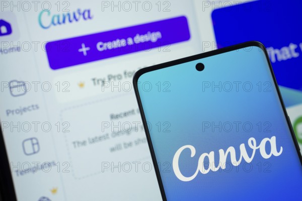 Canva logo is displayed on a smartphone screen, with the canva website visible on a computer screen