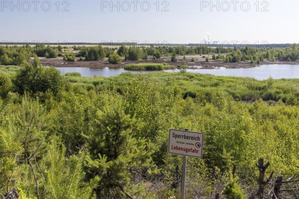 Viewpoint at the still flooded Bergener See with Sperrschidl, in the background the towers of the