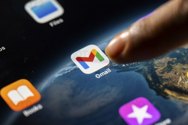 In this photo Illustration a person taps Gmail App icon on a tablet device on 24 May 2025 in New