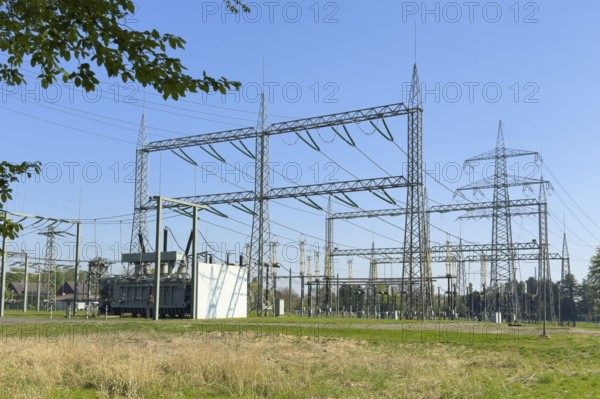 Substation with open-air switchgear for power distribution, in the background high electricity