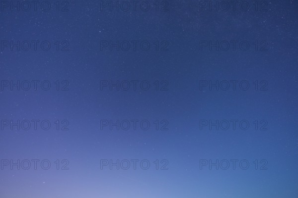 A clear starry sky with soft blue tones at dusk creates a peaceful atmosphere, Spessart, Bavaria