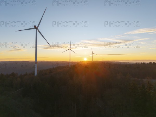 Tranquil landscape with wind turbines at sunrise over wooded area, wind farm, Rems Valley,