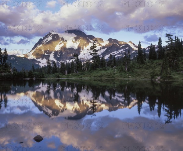 Twilight descends on Mount Shuksan in the North Cascades National Park as its snowy peak reflects