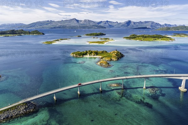 Sommaroy Bridge connecting Kvaloya Island to Sommaroy Island, small islands, mountain range in the