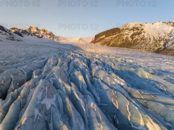 The stunning beauty of the Skaftafell Glacier during winter. The sunlight accentuates the rugged