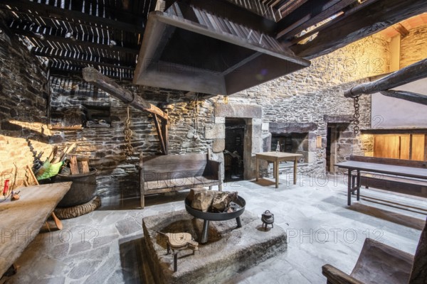 Traditional Lugo, Spain country house featuring rustic stone walls and a large open hearth in a