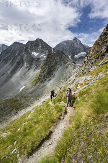 Mountaineer on a hiking trail, mountain landscape, ascent to Col de Riedmatten, behind summit Mont
