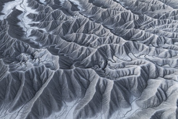 Captivating aerial shot capturing the intricate and rugged landscape of Caineville Mesa, near