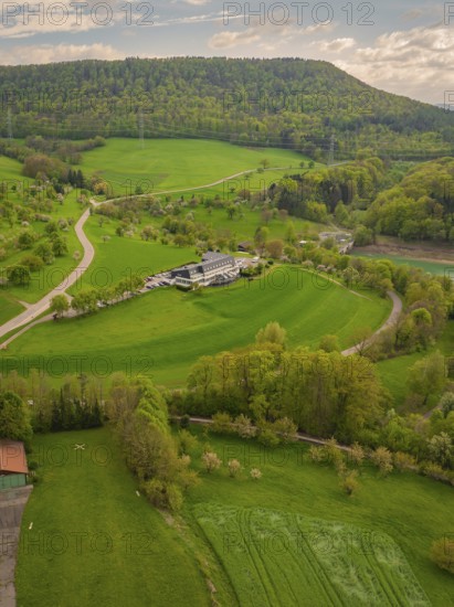 Hotel in the middle of a green hilly landscape with surrounding fields, Glems reservoir, Swabian