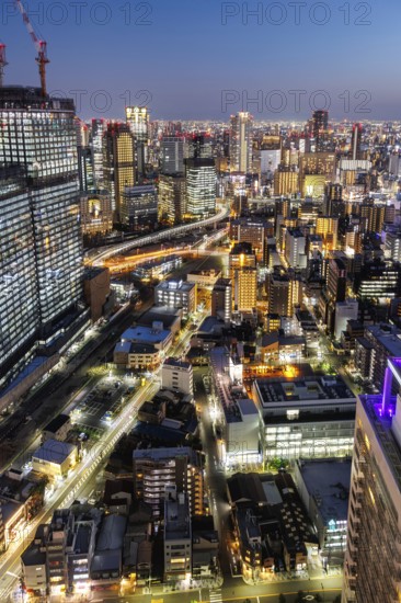 Osaka city from above with the skyline skyscrapers at night in Osaka, Japan