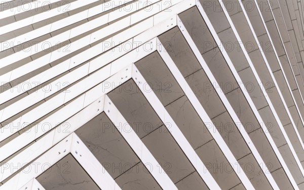 Close-up of a modern architectural facade featuring diagonal lines creating a dynamic pattern. The