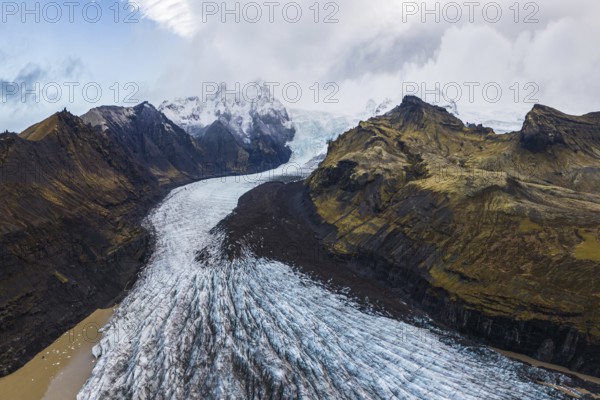 Stunning aerial capture of Vatnajökull Glacier winding through the rugged mountains of Vatnajökull