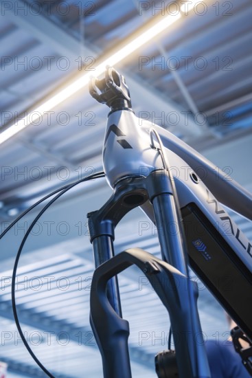 Top view of a bicycle fork and frame with light in a modern workshop environment, Waldbike