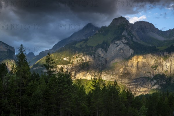 Majestic mountain landscape at Oachinensee, Switzerland, showcasing dramatic clouds and sunlight
