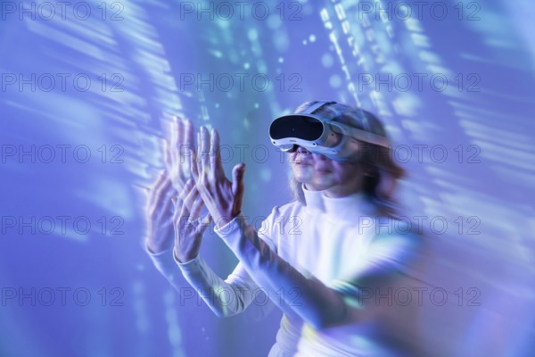 An elderly Asian woman engages with the digital world using a VR headset, illustrating the blend of