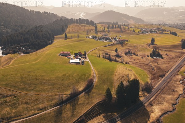 Wide landscape with fields, hills and a village in sunlight, Oberreute, Allgäu, Germany