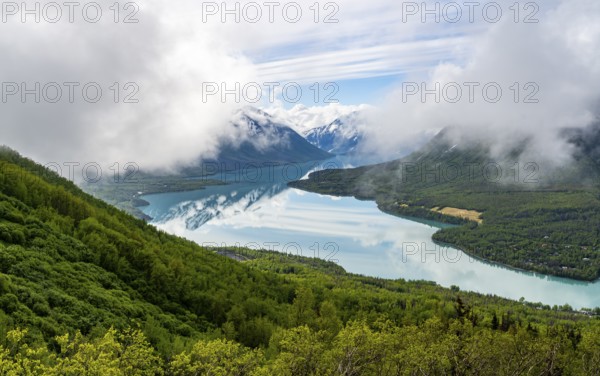 View of snowy mountains in spring and turquoise blue Kenai Lake, Slaughter Ridge Trail, Cooper