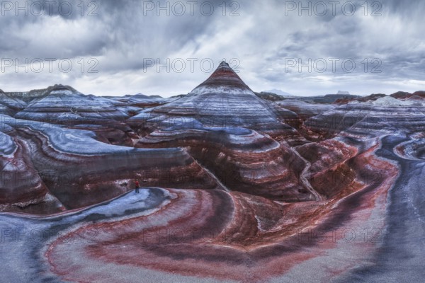 From above aerial drone photograph of an unrecognizable traveler standing on the vibrant and