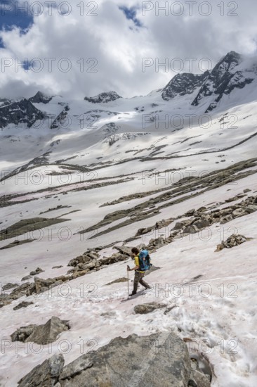 Mountaineer on a snowfield, descent from the summit of Schönbichler Horn, view of snow-covered and