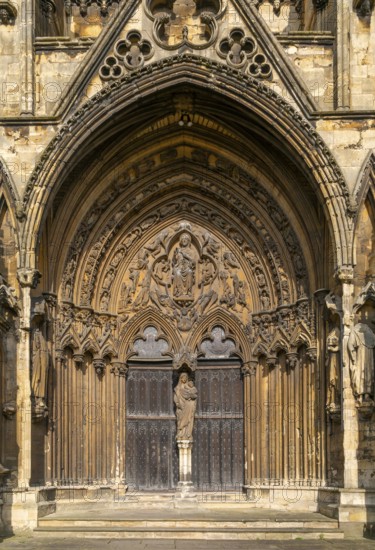 Statue of Mary and baby Jesus in doorway, The Judgement Porch, Lincoln Cathedral, Lincoln,