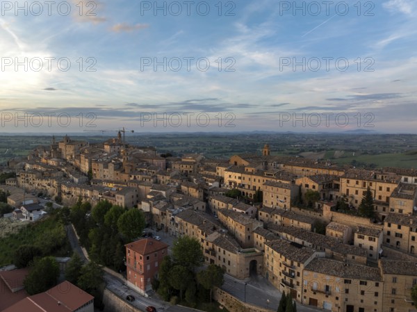 Aerial view of the historic town of Treia in Italy at sunset. The ancient architecture and warm