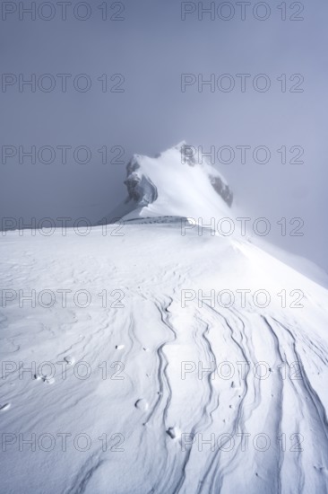 Drifting snow, mountain ridge, snow-covered mountain landscape, ascent to the Wildhorn, cloudy