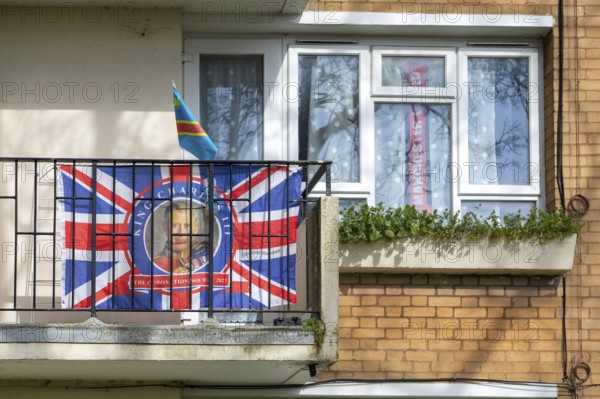 Patriotic Union Jack flag featuring King Charles on balcony of flat, Sydenham, Lewisham, London,