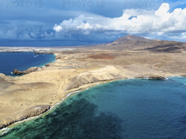 Coast with Playa Caleta del Congrio beach and blue sea, arid landscape of Los Ajaches Natural Park,