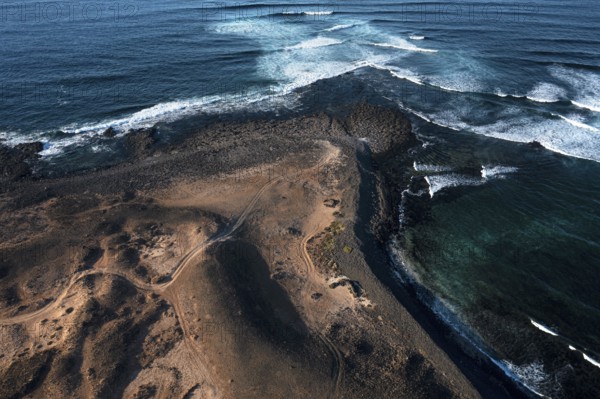 Aerial view of Popcorn Beach, striking coastline with natural volcanic landscapes contrasting