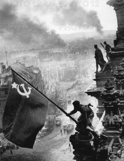 At the Berlin Reichstag, May 2, 1945, three Soviet soldiers fly the flag of the Soviet Union. The
