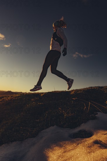 Trail running in autumn on the Jochberg on Lake Walchensee against the wonderful backdrop of the