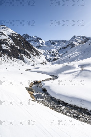Funtauna Valley with mountain stream and snow in winter, Graubünden Haute Route, Albula Alps,
