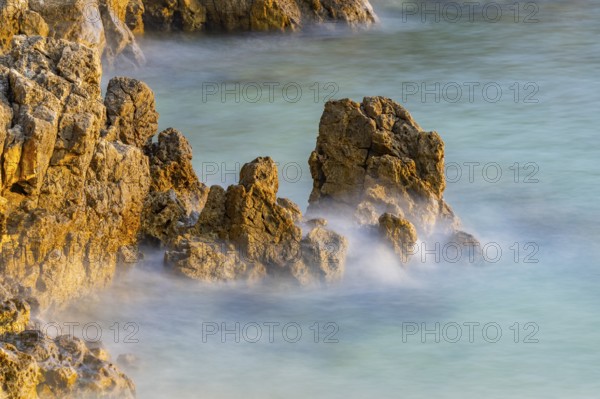 Crystal clear and turquoise water on the beach of Ustrine Bay on a sunny day at sunset on the