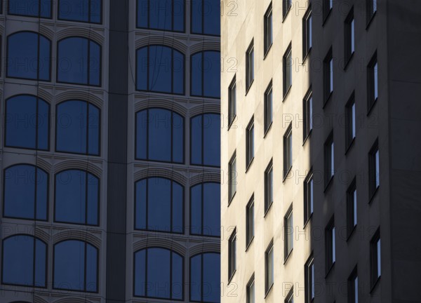 Architectural styles of two adjacent modern buildings in New York, capturing their unique facades
