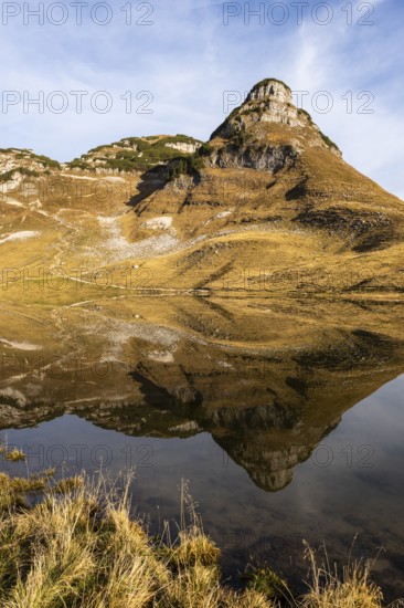 Lake Augstsee and the Atterkogel mountain on the Loser. Autumn, good weather, blue sky. Reflection.