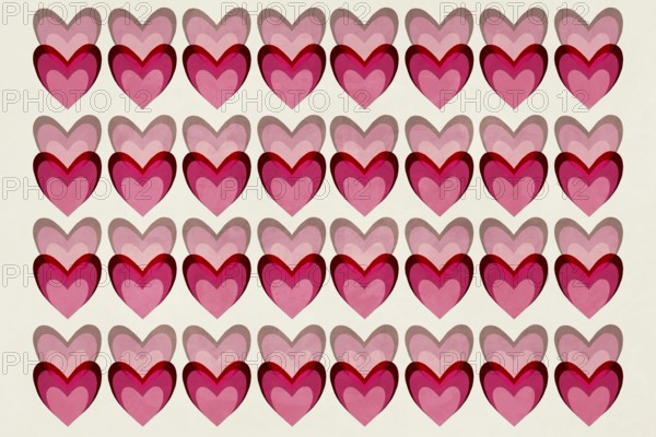 A seamless pattern of overlapping hearts in vibrant shades of pink and red, creating a playful and