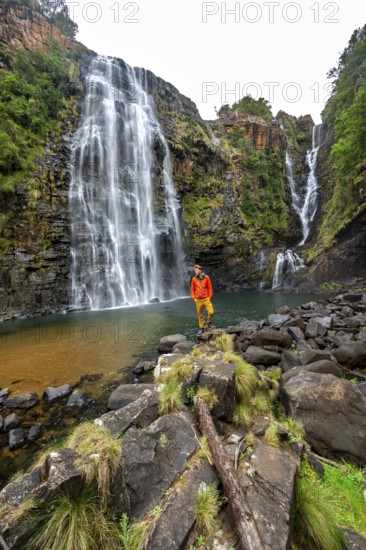 Young man standing in front of a waterfall, Lisbon Falls, long exposure, near Graskop, Mpumalanga,