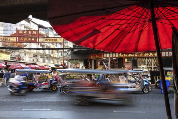 Bangkok, Thailand. March 25th 2025. Busy evening traffic of tuk-tuk and taxis passing popular
