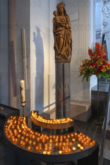 Sculpture of the Virgin Mary in front of sacrificial candles, St Kilian's Cathedral, Würzburg,