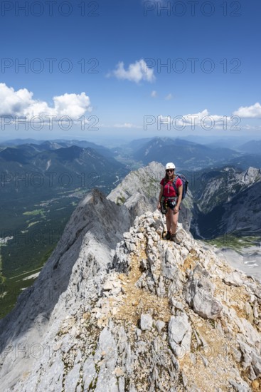 Mountaineer with helmet on a mountain ridge, ascent to the Zugspitze, Zugspitze via ferrata,