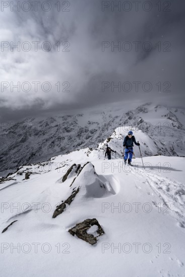 Ski tourer, ascent to the summit of the Köllkuppe or Cima Marmota, snow-covered mountain landscape,
