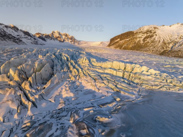 The stunning beauty of the Skaftafell Glacier during winter. The sunlight accentuates the rugged